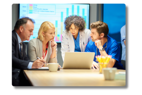 Healthcare and business leaders reviewing computer screen